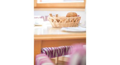 a basket of food sitting on a table with plates at Apartment Alouette in Samnaun