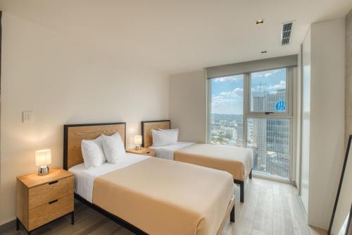 Postel nebo postele na pokoji v ubytování Nido Nomad Las Américas GDL