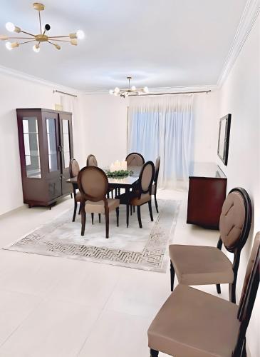 a dining room with a table and chairs at Modern Flat at Shiekh Zayed in Sheikh Zayed