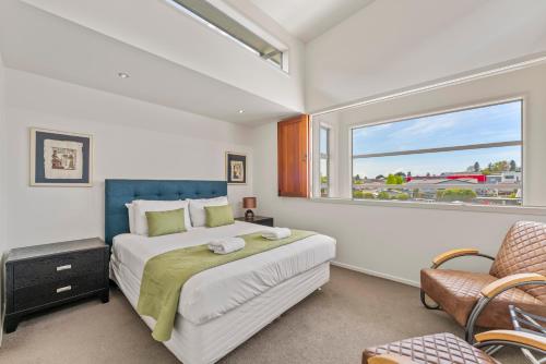 a bedroom with a large bed and a window at Stay Central Taupo in Taupo