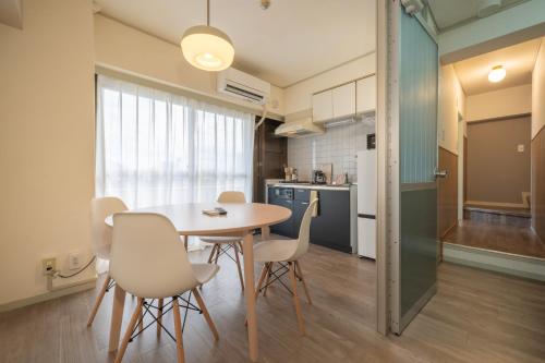 a kitchen and dining room with a table and chairs at AS Residence Komagome in Tokyo