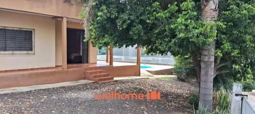 a house with a tree in front of it at Casa em Chapeco com Piscina e Vista da Montanha in Nonoai