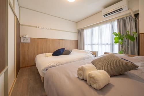 a hotel room with two beds and a window at AS Residence Komagome in Tokyo