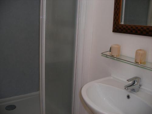 a bathroom with a shower and a sink at Hôtel Modern in Concarneau