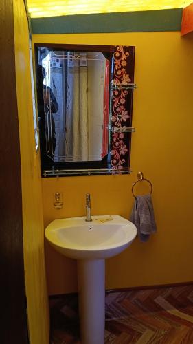 a bathroom with a white sink and a mirror at cabañas del inka in Puno