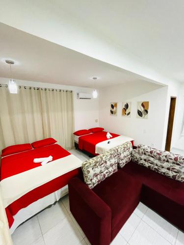 two beds and a couch in a room at Suíte Lunar Prime in Serra de São Bento
