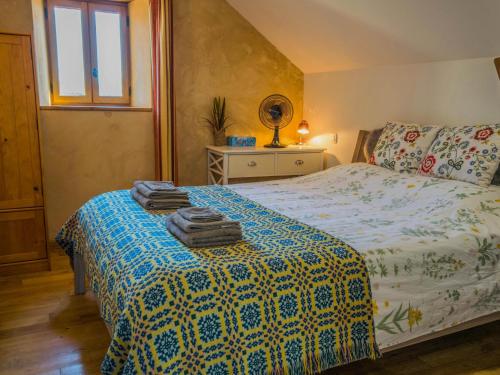 a bedroom with a bed with towels on it at Mas dAmour in Montcabrier