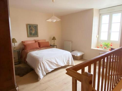 a bedroom with a bed with pink pillows on it at Amazing holiday home in the Heart of Vittel in Vittel