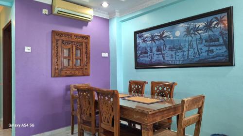 a dining room with a wooden table and chairs at ARIAN GOLDSAND SEAVIEW APARMENT glory beach resort in Port Dickson