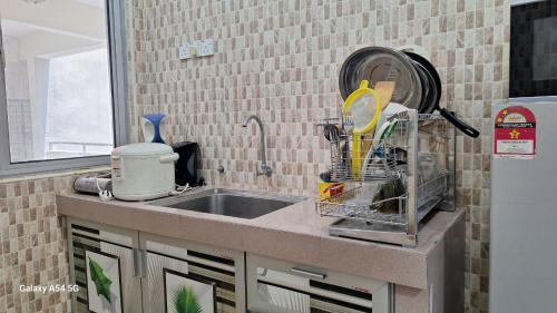 a kitchen counter with a sink and a mixer at ARIAN GOLDSAND SEAVIEW APARMENT glory beach resort in Port Dickson