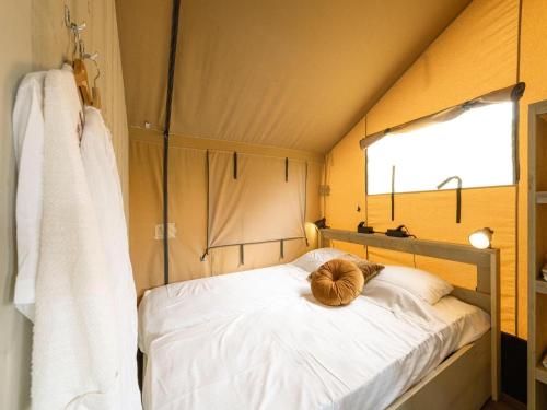 a teddy bear sitting on a bed in a tent at Luxury holiday home in Overijssel in Balkbrug