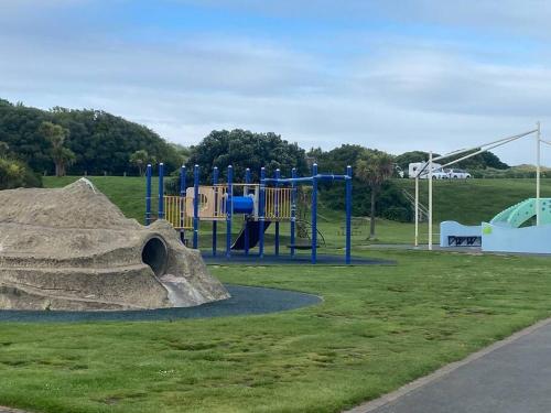 a playground in a park with a rock at Rose Cottage - Charming 2 Bedroom Home in Dunedin