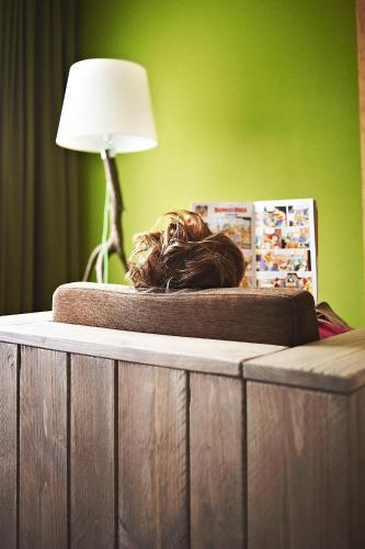 a table with a wig on top of it with a lamp at Hotel Zugbrücke Grenzau GmbH in Höhr-Grenzhausen