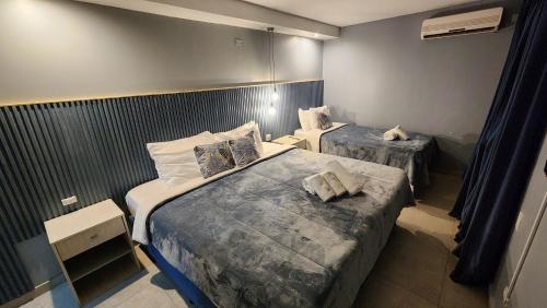 a bedroom with two beds in a room at Essencial Hotel Spa in Mendoza