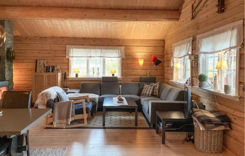 a living room with a couch and a dog at 3 Bedroom Beautiful Home In Straumgjerde in Brunstad