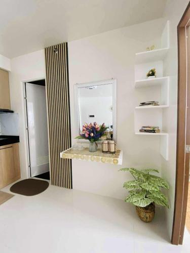 a room with a mirror and a plant on a shelf at Casa Solana in Butuan