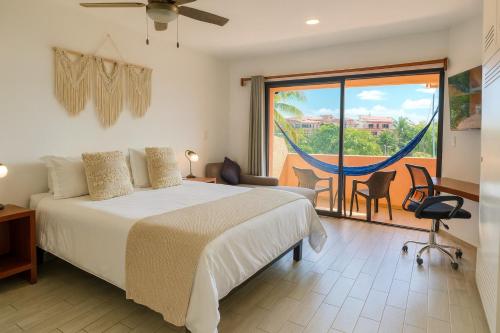 a bedroom with a bed and a view of a balcony at Ocean & Marina views,Affordable,Spoil yourself! in Puerto Aventuras