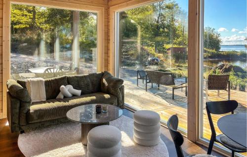 a living room with a couch and a large window at Gorgeous Home In Bolmsö With Lake View in Bolmsö