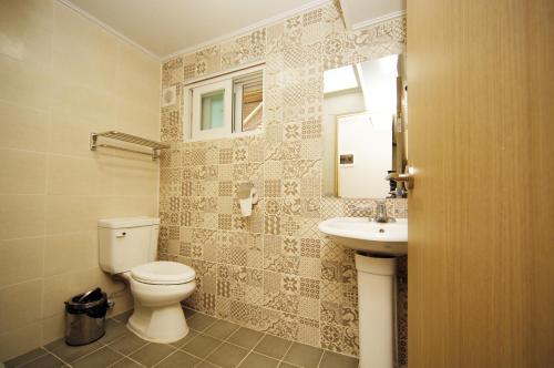 a bathroom with a toilet and a sink at 24 Guesthouse KyungHee University in Seoul