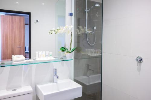 a bathroom with a sink and a shower at Crest on Barkly Hotel in Melbourne