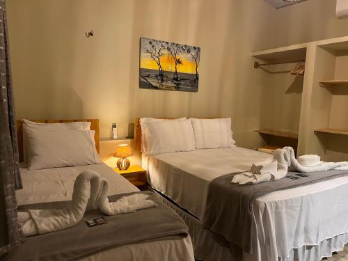 a bedroom with two beds with towels on them at The Jungle, Guriú, CE in Guriú