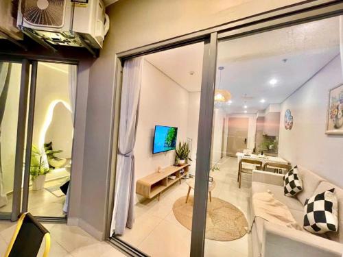 a living room with a couch and a tv at The Sóng Apartment Vũng Tàu - Nhà Chill in Vung Tau