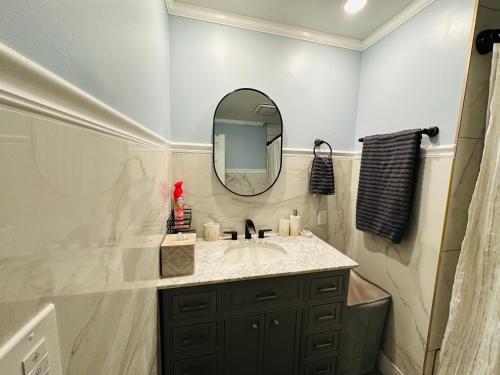 a bathroom with a sink and a mirror at The Peaceful Perch Retreat Near NYC Elle's Home in Trenton