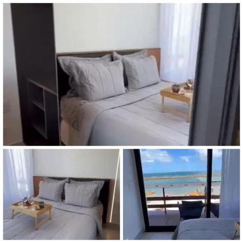 une chambre avec un lit et une vue sur la plage dans l'établissement Resort porto life2, à Ipojuca