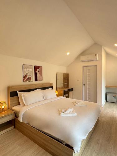 a bedroom with a large bed in a attic at Seashell Family-555普吉岛木屋走几步到邦涛海滩看日落周边餐饮方便 in Bang Tao Beach