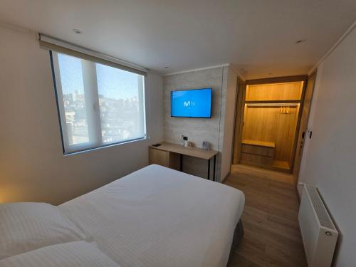 a hotel room with two beds and a television at Arka Hotel in Viña del Mar