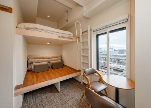 a small room with a bed and a desk and a window at Tabist TOKYO CITY VIEW HOTEL in Tokyo