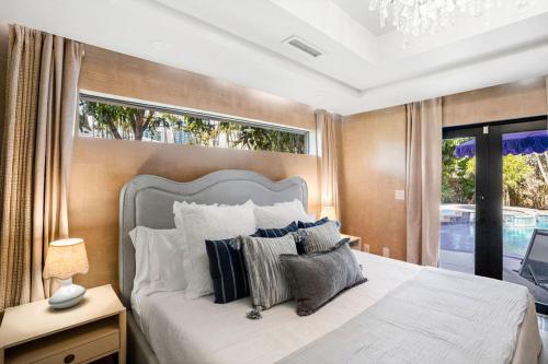 ein Schlafzimmer mit großem Bett und Fenster in der Unterkunft The Coastal Duo Escape in West Palm Beach