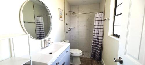 a white bathroom with a sink and a mirror at Lovely House in Sarasota close to UTC Mall Nathan Benderson Park and Siesta Key Beach in Sarasota