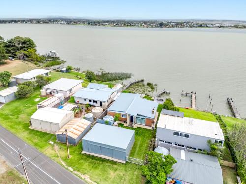 an aerial view of a house with the water at Riverside Retreat - Waterfront - Hindmarsh Island - Linen Included in Hindmarsh Island