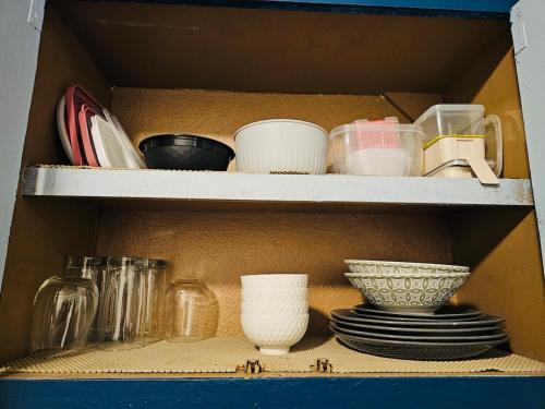 a shelf with plates and bowls and other dishes at Pedro's Place Peaceful 1 bedrm, 1 bathrm Villa in Sinajana