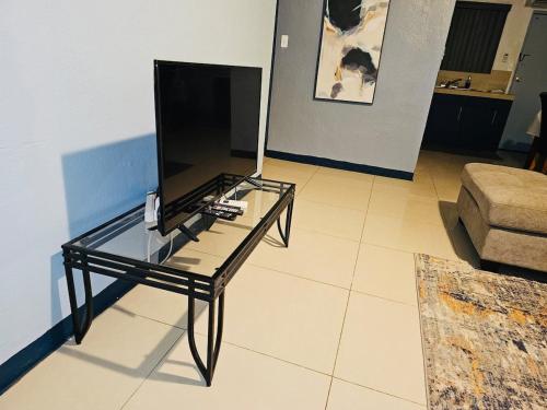 a glass table in a living room with a television at Pedro's Place Peaceful 1 bedrm, 1 bathrm Villa in Sinajana