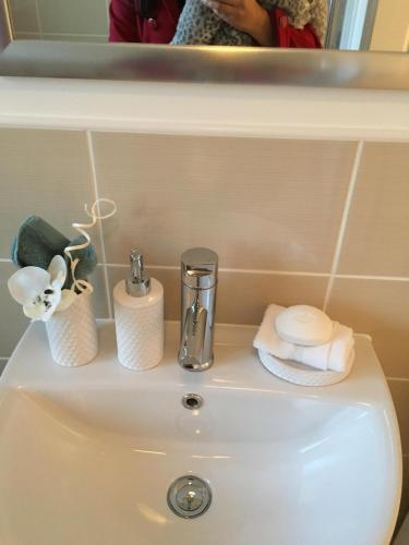 a bathroom sink with a faucet and towels on it at Premier stays in Warrington