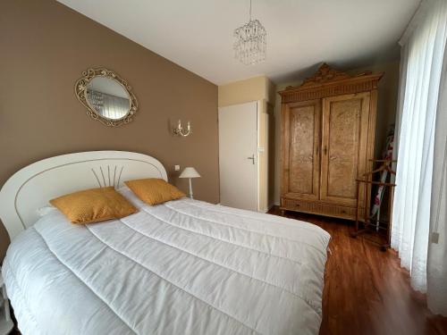 a bedroom with a large white bed with two pillows at Appartement Tout Confort entre Plage et Commerces à Saint-Brevin-les-Pins - FR-1-364-55 in Saint-Brevin-les-Pins