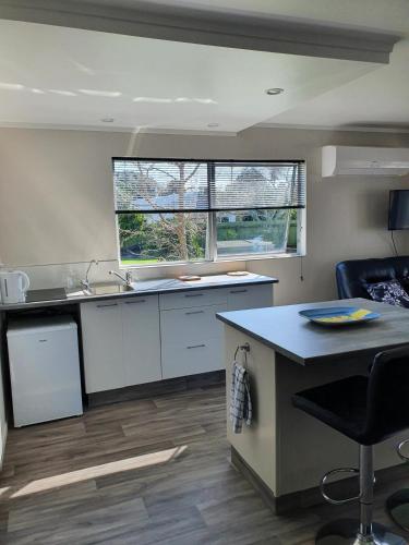 a kitchen with a sink and a counter top at Harbour Views House or Flat in Tahawai