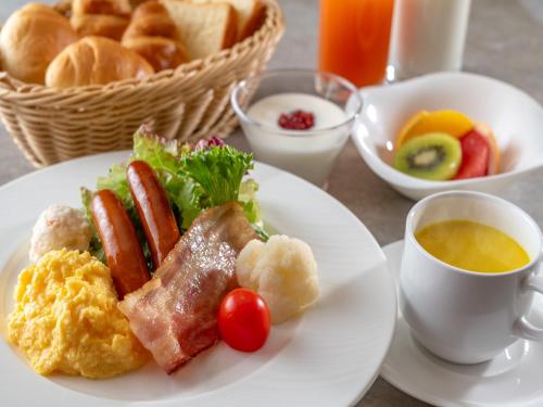 a plate of breakfast food with bread and a cup of coffee at Yatsugatake Wan Wan Paradise Cottage in Hokuto