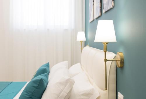 a bedroom with a bed with a lamp and pillows at boutique teatro b&b in Foggia
