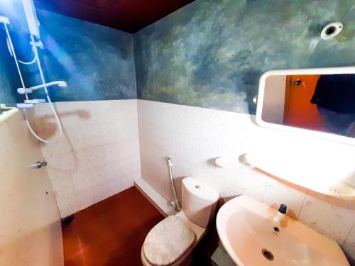 a bathroom with a toilet and a sink at Awinco Rest Inn in Haputale