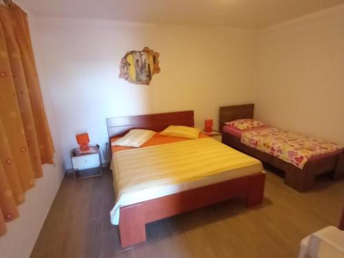 a bedroom with two beds in a room at Comfort One Bedroom Apartment with Terrace and Sea view in Sveta Nedelja