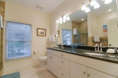 a bathroom with a sink and a toilet and a mirror at SM04: 4 Silver Moss in Kiawah Island