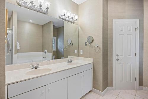 a bathroom with a sink and a large mirror at SM05: 5 Silver Moss in Kiawah Island
