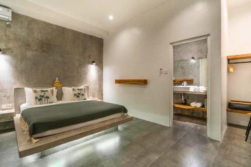 a bedroom with a large bed and a bathroom at Deimena Cozy 3 BR Private Pool Villa ZN353 in Pererenan