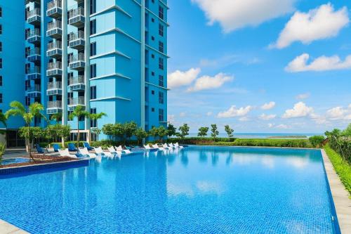 an image of a swimming pool in front of a building at Modern Seaview 1BR Near Okada Manila Bay Airport 17 in Manila
