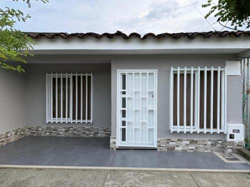 a house with white doors and windows on it at Hostal Maxim in Lemos
