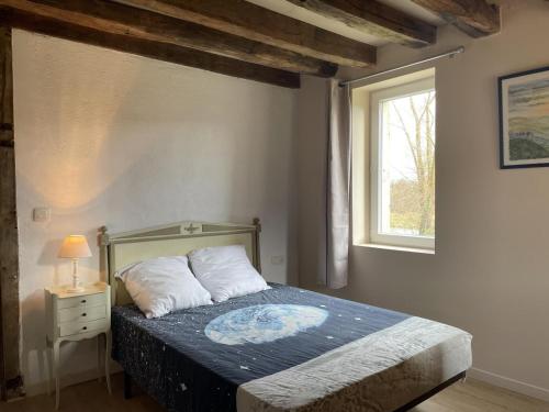 a bedroom with a bed and a window at Gîte chaleureux à Chapeau avec jardin et terrasse - FR-1-489-601 in Chapeau