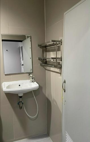 a bathroom with a sink and a mirror at Phimpakan guesthouse in Nakhon Phanom